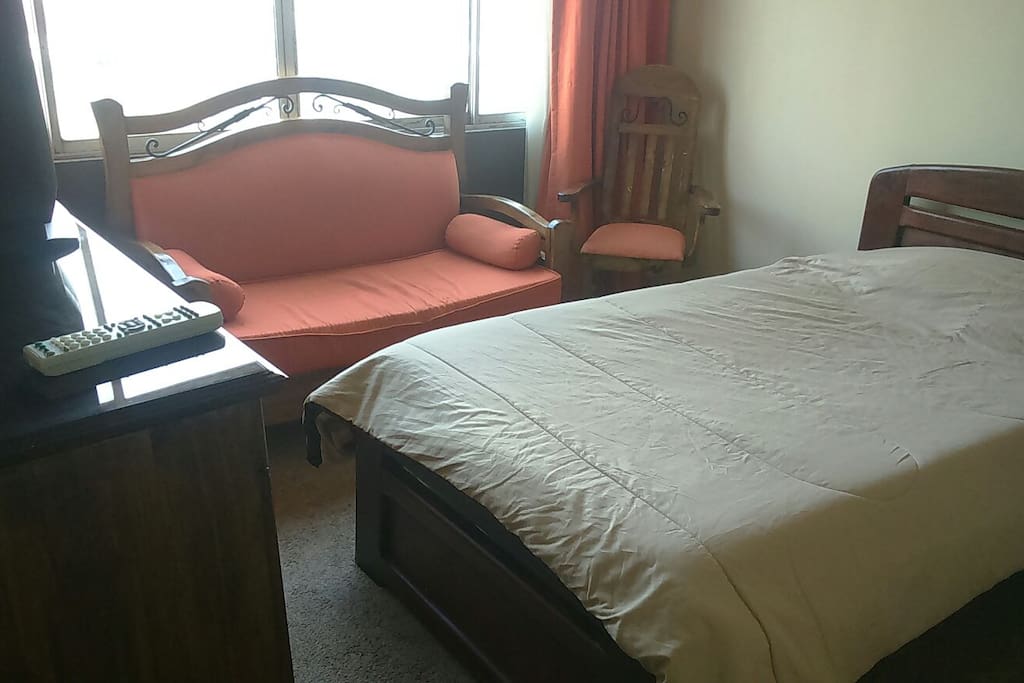 Bed and sofa, room with city view