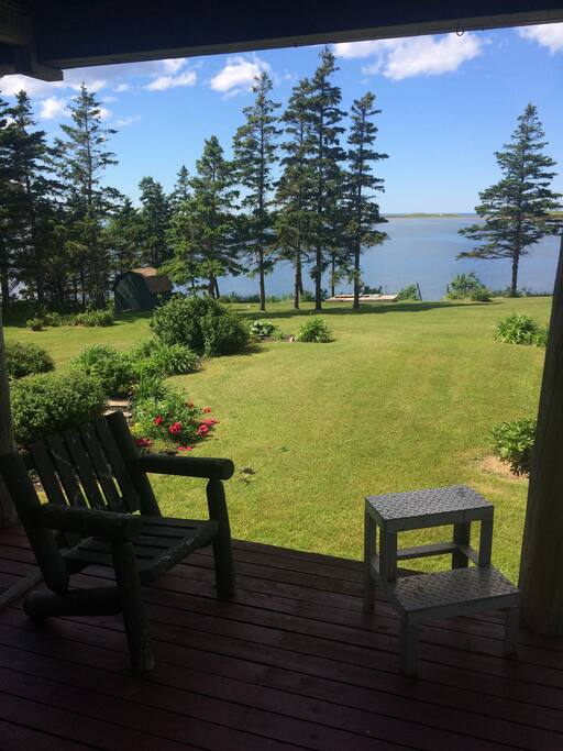 Large screened in deck with a BBQ and overlooking lovely waterfront location.