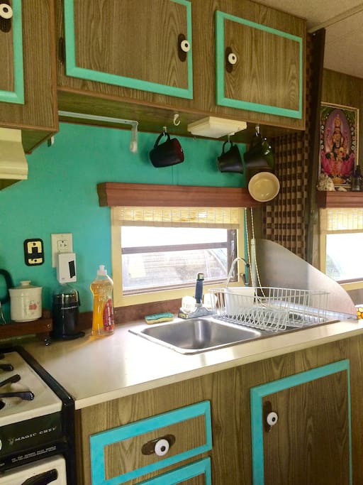 Sink with hot water and gas stove and oven.