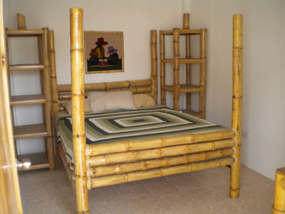 Handmade bamboo furniture with 1500 thread count sheets.