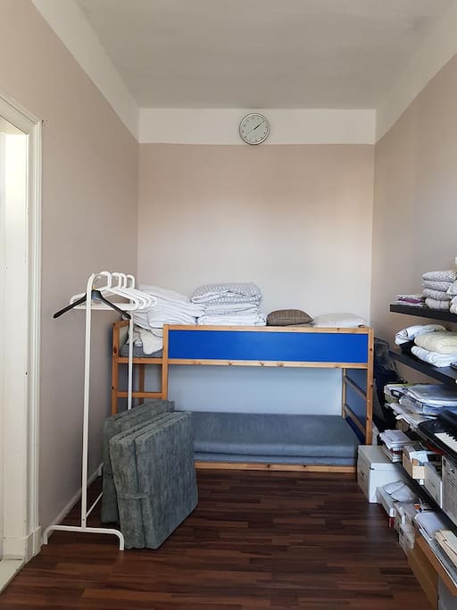 Bed side of room with folding futon matresses