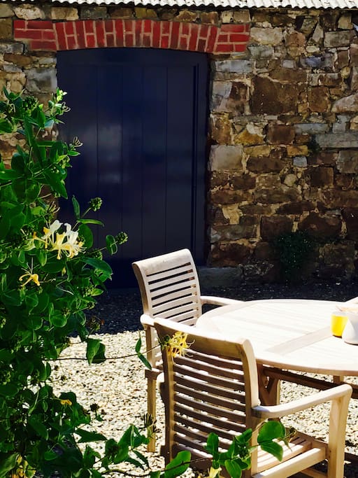 Private garden to rear of cottage, gravelled and a raised decked terrace.