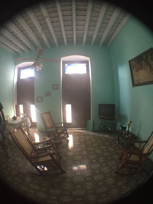 A big, private living room with doors that open onto the street below.