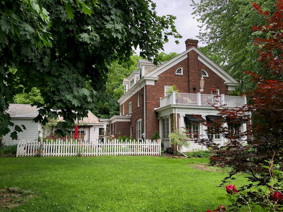 The west side of the house, terrace, courtyard and art studio. Even room for a game of croquet!