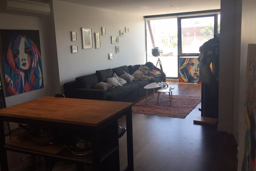 Lounge room which connects to open kitchen and floating bench
