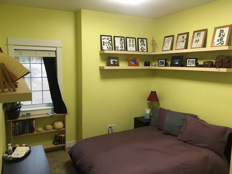 Full size bed and Japanese decor.