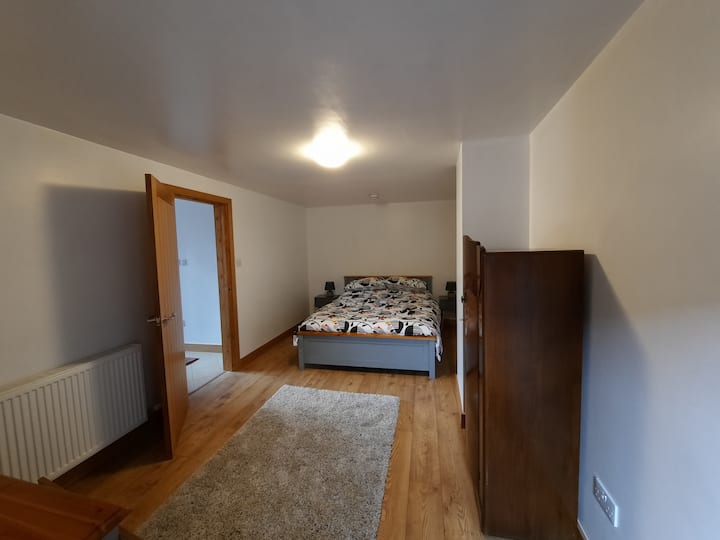 Downstairs second bedroom with a king size bed.