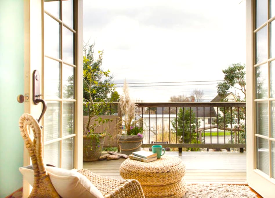 French doors open onto a large balcony with peek-a-boo views of Fidalgo Bay and Mt. Baker.