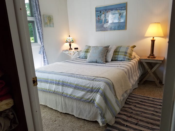 Main bedroom with queen bed, located on the main floor.