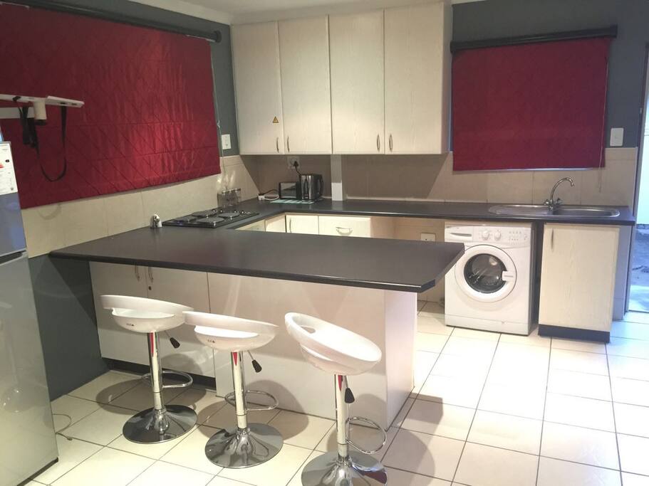 This is the kitchen. Fridge, washing machine, breakfast nook, stove, microwave, kettle, cutlery and crockery all included.