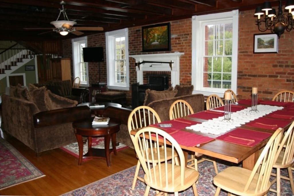 Hardwood floors, exposed brick walls, and exposed beam ceiling. Dining table seating for 10!