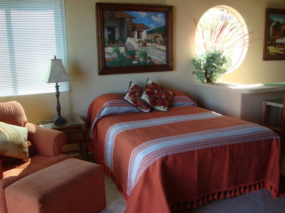Penthouse bedroom, and comfy chair to watch TV