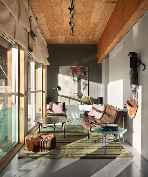Lounge while gazing out large windows, which have an expansive view of the property.