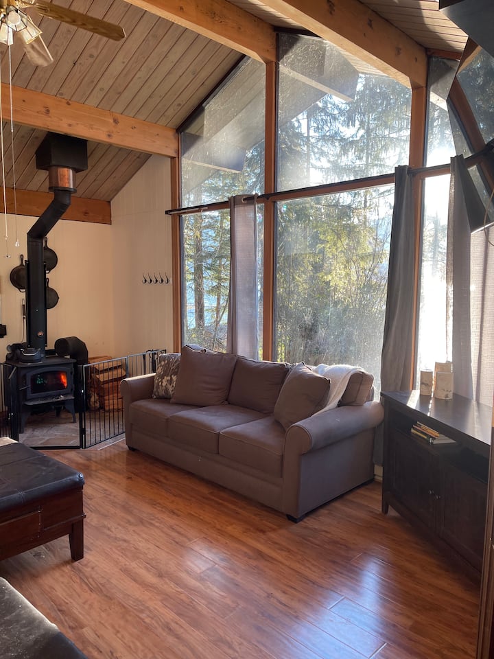 Living room area with high ceilings and views of the lake