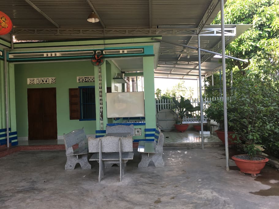 Front yard with tables and chairs, that great place for have a cup of coffee at morning