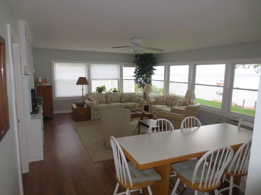 Great room with full lake view, ample seating for dining and relaxation.