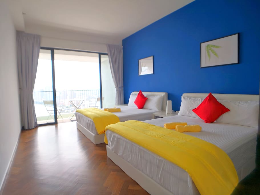 Master bedroom with 2 queen size beds and a private seaview balcony.