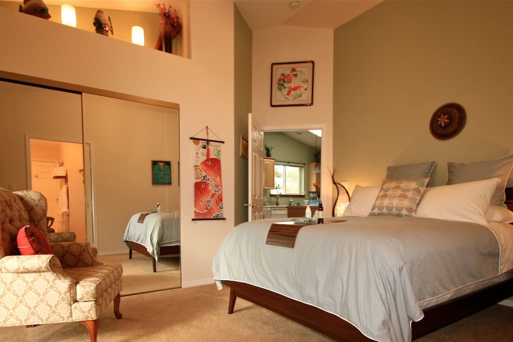The Deluxe Master Suite has luxurious bedding and a slider to back deck.