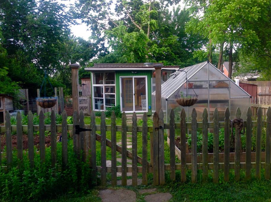 Chickens, fenced in garden with raised beds, and a sun porch.