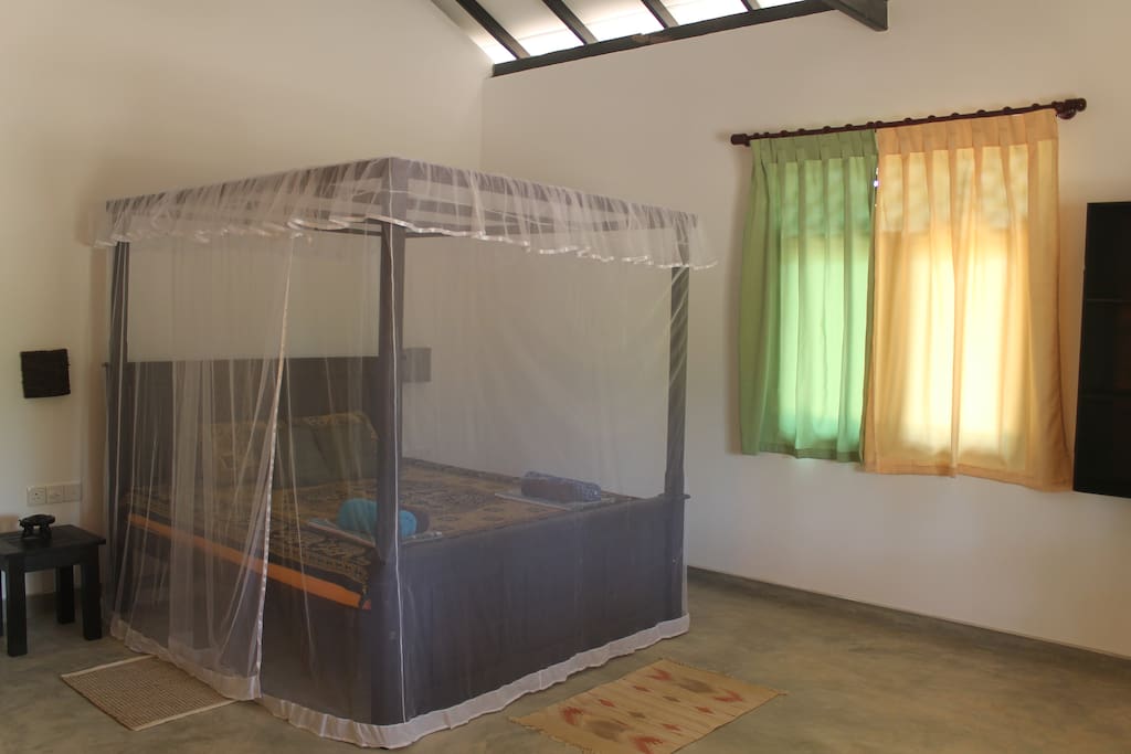 king-size bed with mosquito net
