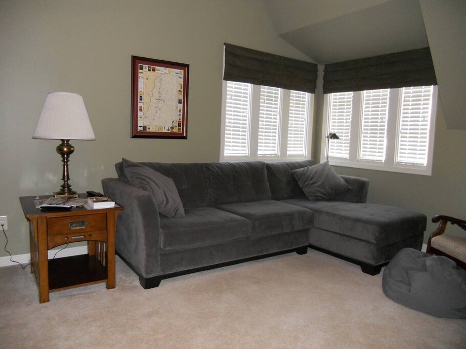 Comfortable, private sitting area with couch and 55-inch HDTV. Includes work space with desk, office chair and Wifi.