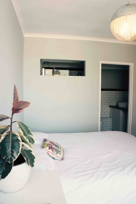 bedroom view with bathroom in background