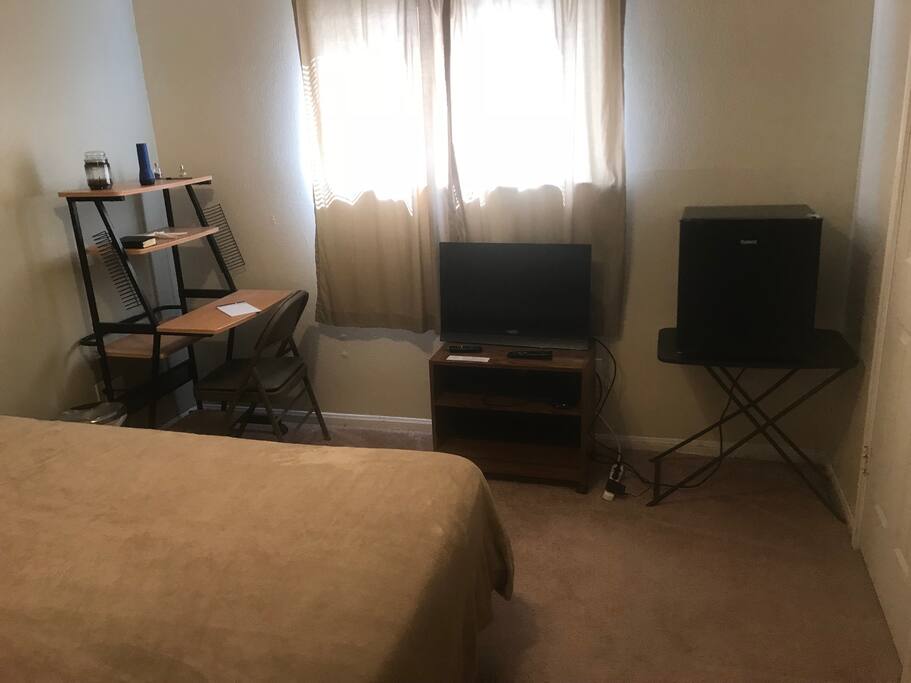 Private Bedroom with King Size Bed, TV and refrigerator