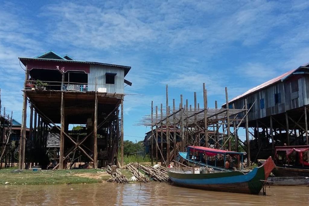 Kampong Pluk is about 20 Km locates on the Southeast of Siem Reap Town.
Over 3000 inhabitants are real Khmers, their households made of wood and bamboo built on stilts of about 6m to 7m high. During dry season when the lake is low and lack of water those buildings look like the skyscrapers. At this time of the year many of villagers move out onto the lake and build a provisional stilted houses. In wet season while the water level rises up again, the dwellers move back to their permanent houses on the flood plain, the stilts now hidden under the water. People made a living by catching fishes produce as well as smelly fish paste, fermented fish, smoked fish, dried fish, dried prawn etc.