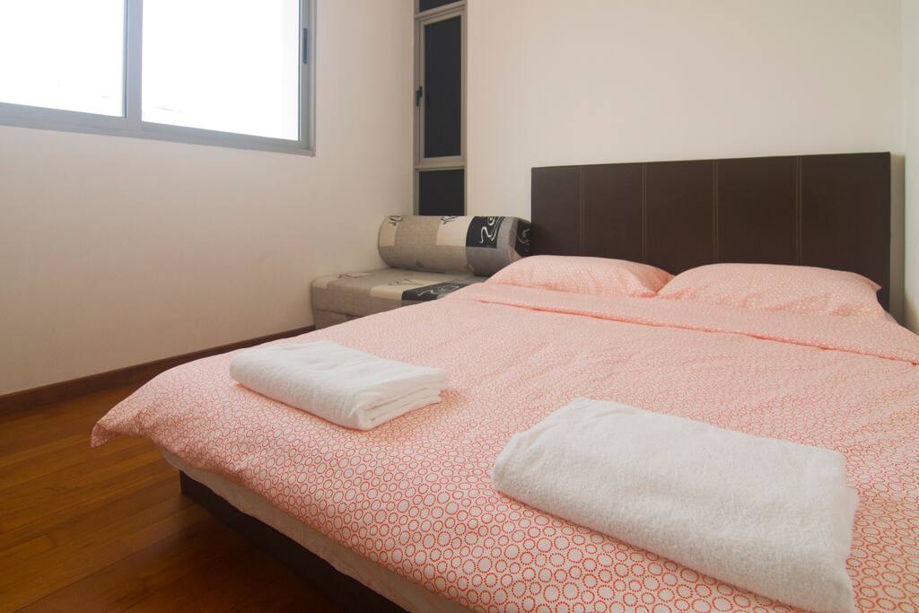 1st bedroom with a queen size bed, with a small sofa bed