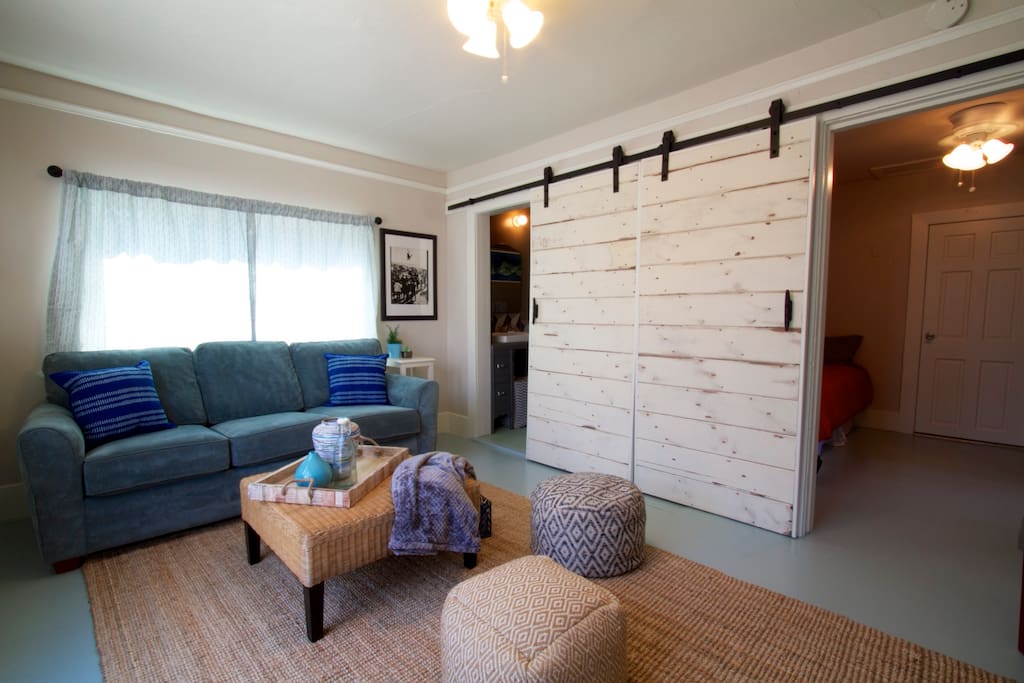 Large shiplap barn doors lead to bedroom #2 and bath
