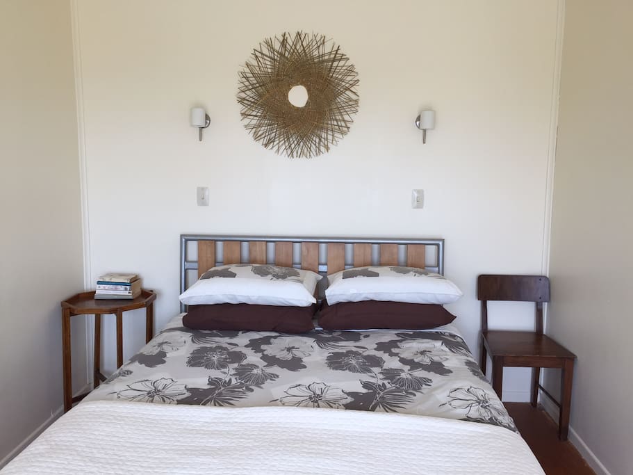 Queen bedroom leads onto deck with glorious sea view.