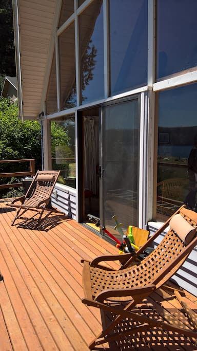 Floor to ceiling windows lead to large beachfront deck.