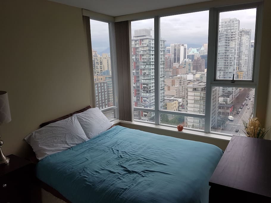 Comfortable queen-sized bed with bathroom adjacent. Ability to adjust the vertical blinds: closed for ultimate privacy or open to let the sunshine in and enjoy the view!
