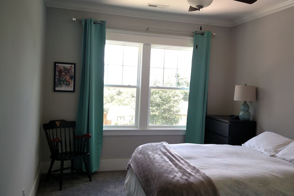 private room with comfortable queen sized bed and ceiling fan