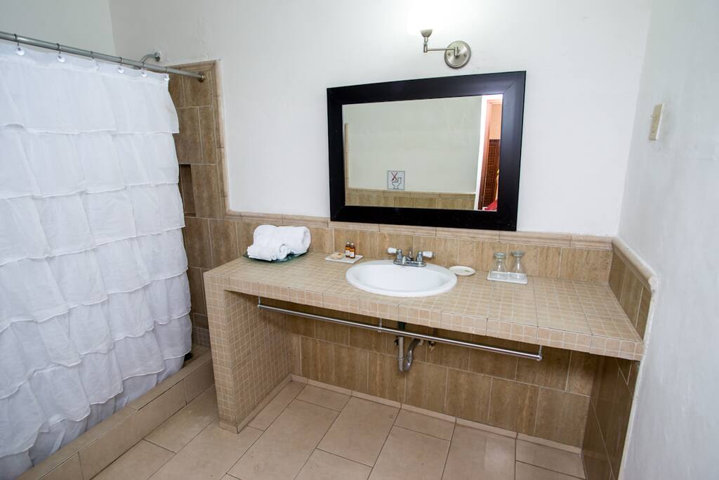 Fully equipped large bathroom with shower and local honey organic amenities