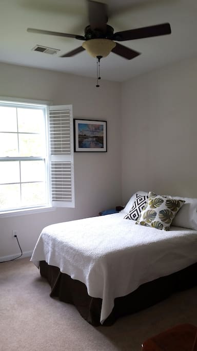 The bedroom has a ceiling fan.