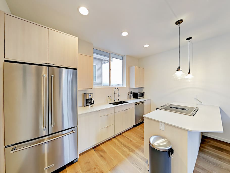 Contemporary appliances include a French-door refrigerator.