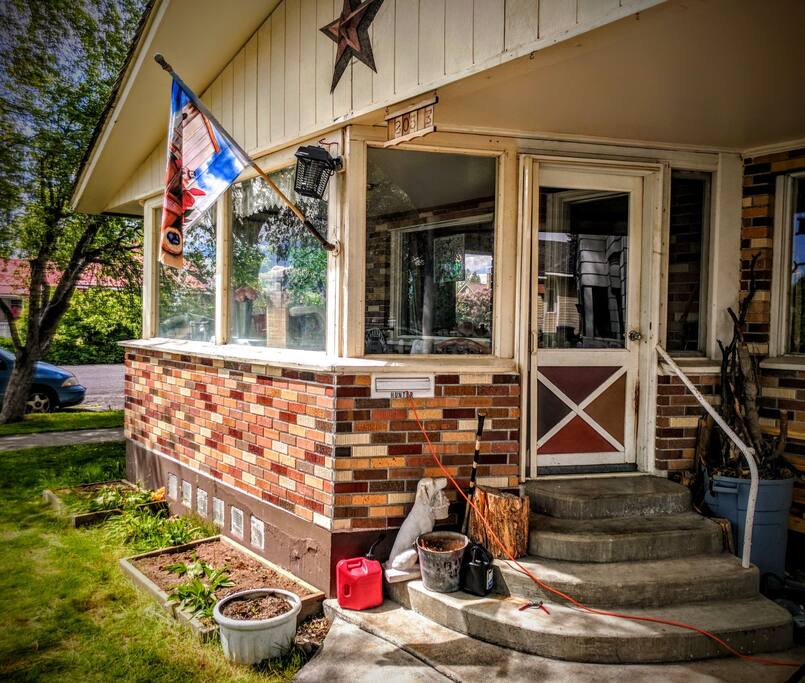Front door entrance has a few steps and opens onto an enclosed porch.
