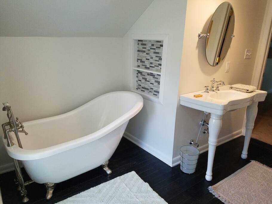 Modern clawfoot tub in private bathroom.