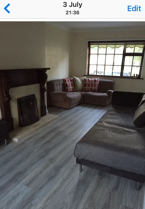 Sittingroom with open fire and tv