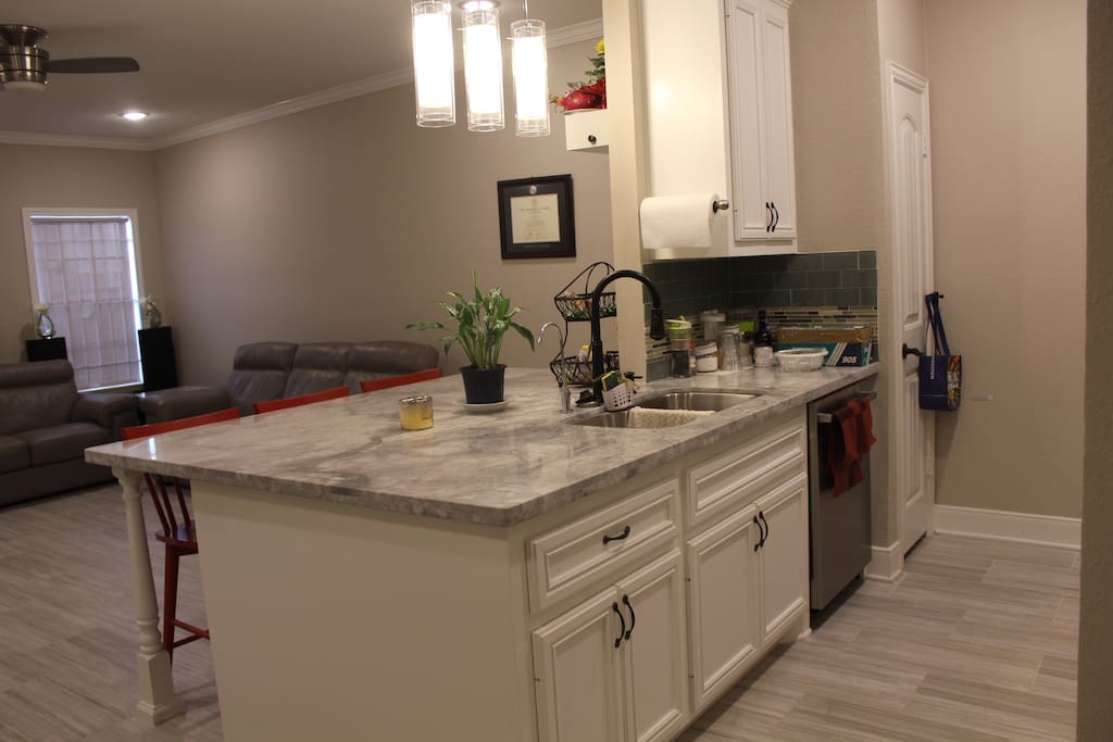 Kitchen with granite countertop and bar stools