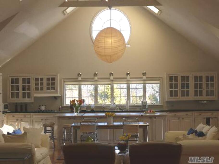 60 ft. wide gourmet kitchen with eat-in island and modern appliances.