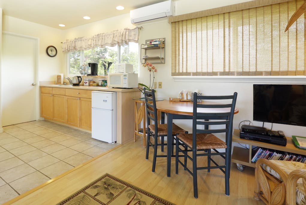 The kitchenette features lots of counter top appliances.