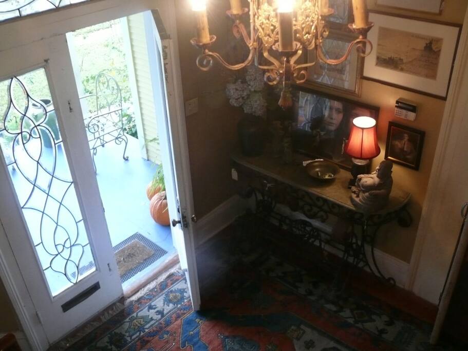 The home has an elegant foyer with leaded glass doors where this historic homes entrance staircase has 14 foot ceilings.