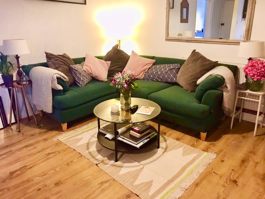 The living room with cosy blankets and flowers