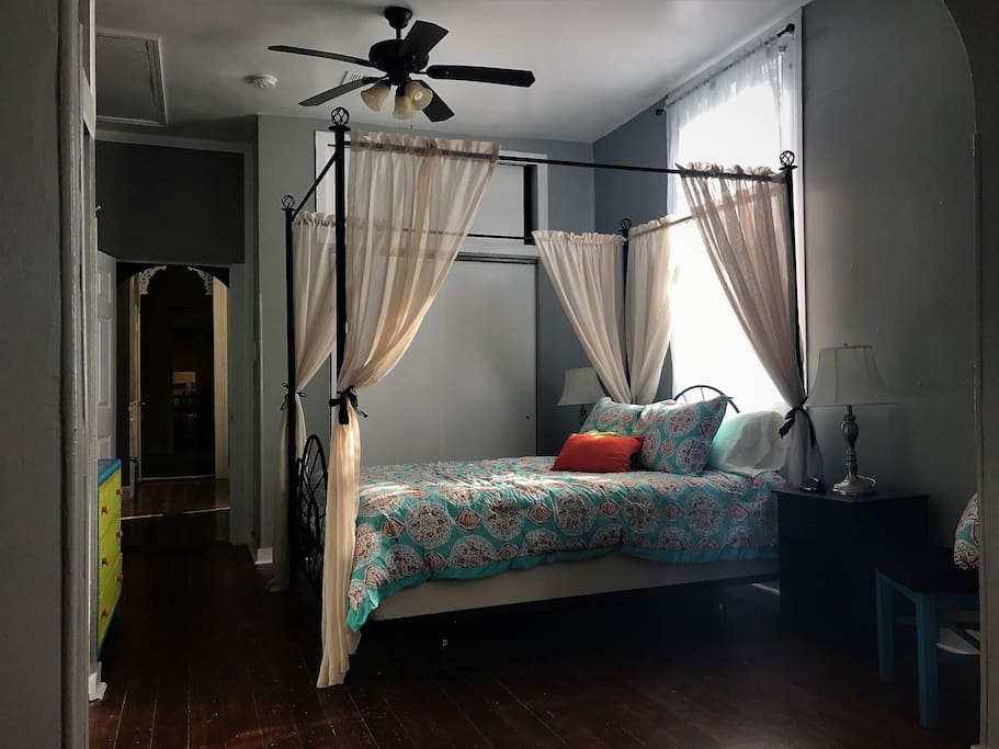 Off the living room is the master bedroom with a beautiful queen canopy bed to enjoy