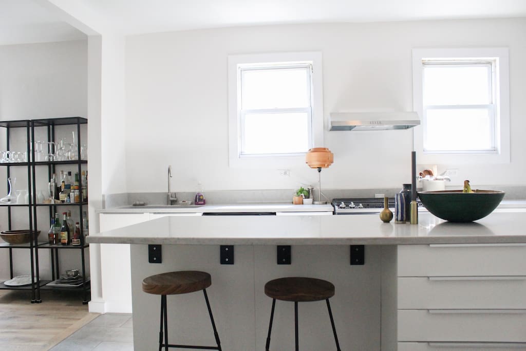 2 handmade barstools tucked under island overhang