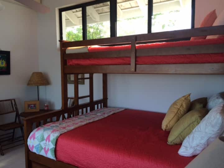 dormitorio infantil con dos camas individuales y una cama tamaño queen, todos los colchones y sábanas nuevos