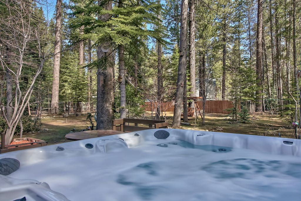 Relax your muscles after a day of nearby adventures in the back deck hot tub with room for 6