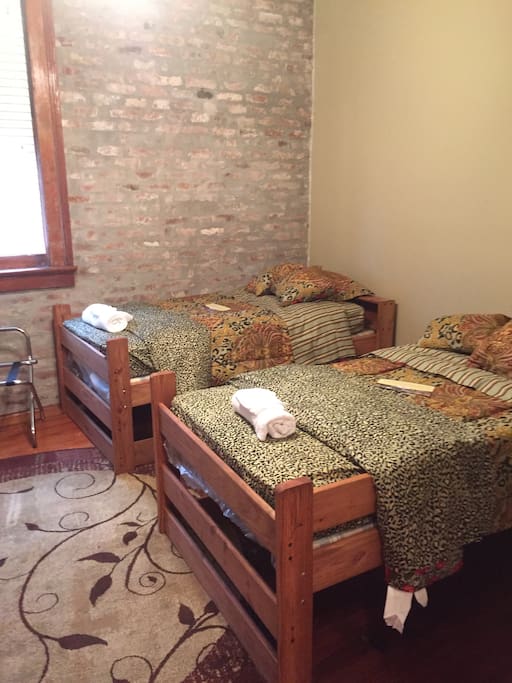 Two single beds, hard wood flooring, 12 foot ceilings, 160 year old non working fire place